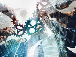 Business team connect pieces of gears. Teamwork, partnership and integration concept. double...