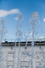 Jets of fountain against gray building