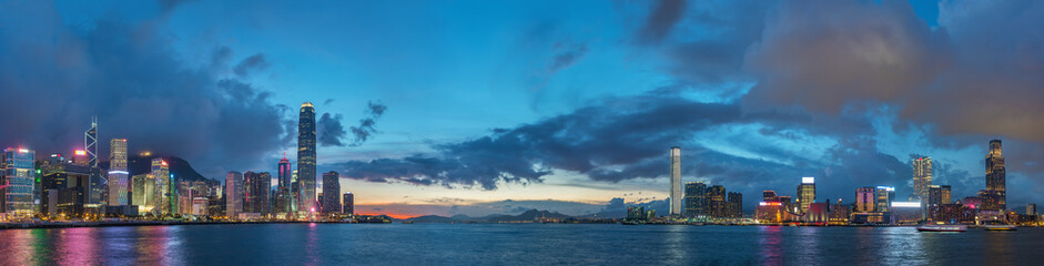 Panorama of Skyline and harbor of Hong Kong city at dusk - obrazy, fototapety, plakaty