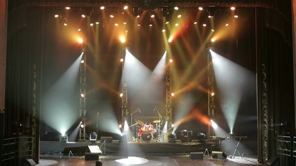 Colorful Stage lights at concert. Stage lights and smoke. Colored lights on an empty concert stage with smoke.
