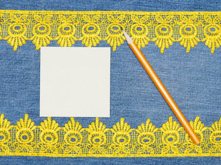 Yellow lace, pencil, note on a jeans background. Sewing still life