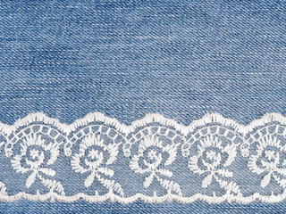 White lace on jeans background. Sewing still life