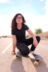 portrait of a teenager skater girl at the city