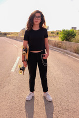 portrait of a teenager skater girl at the city