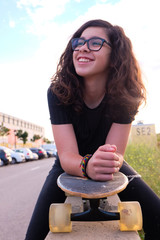 portrait of a teenager skater girl at the city