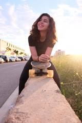 portrait of a teenager skater girl at the city