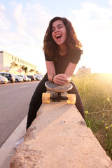 portrait of a teenager skater girl at the city