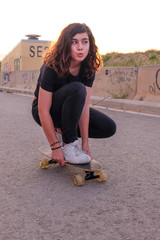 portrait of a teenager skater girl at the city