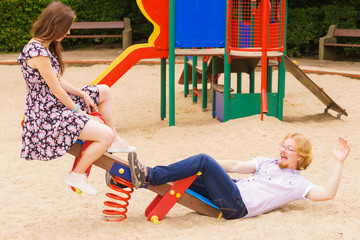Fototapeta na wymiar Funny couple playing on playground
