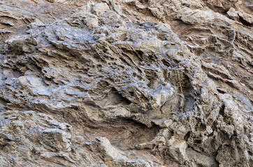 Natural stone texture. Natural texture of the rock surface, where you can see the lines drawn in the long of time. Can be used as background.