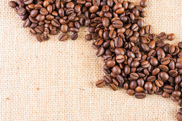 Coffee beans on a background of burlap. Place for text. Concept of making coffee, coffees.