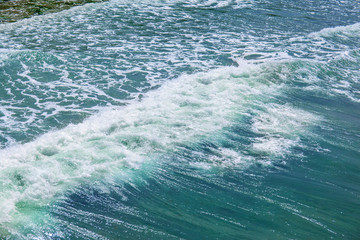 small waves on the surface of the blue sea