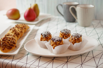 funnel cakes bicolor forelle pear cookies coffee mugs on a geometric patterned tablecloth