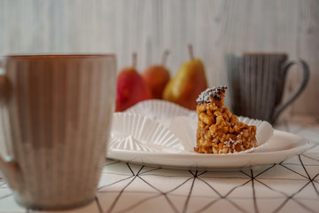 bitten off funnel cakes bicolor forelle pear coffee mugs on a geometric patterned tablecloth