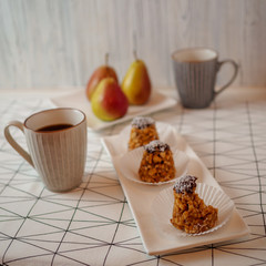 bitten off funnel cakes bicolor forelle pear coffee mugs on a geometric patterned tablecloth
