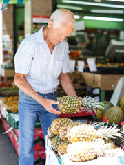 Man choosing fruits in market