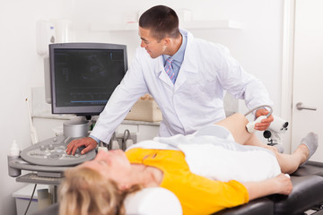 Doctor using ultrasound scan examining patient in hospital