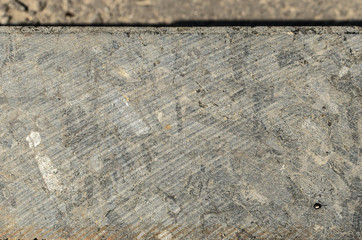 The texture of the curb near the roadway