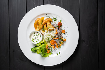 herring with baked potato and sauce