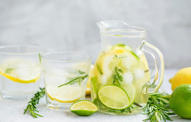 Obraz na płótnie Canvas Lime, lemon , rosemary lemonade with ice cubes, refreshing summer drink