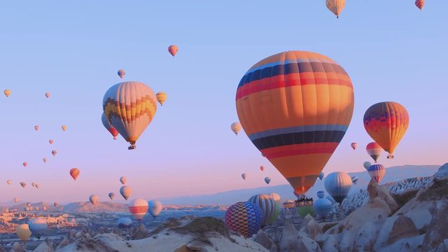 hot-air balloons flying over the mountain landsape of Cappadocia,Turkey.