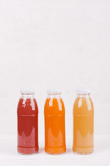 Bottles with colorful fruit juice
