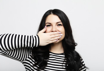 shocked woman keeps mouth widely opened, looks at camera, wears casual clothes.