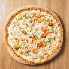 tasty italian pizza on the wooden background