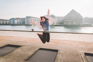 adult person rejoices like child. Playground trampoline in ground, children trampoline, springs...