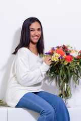 Cute brunette woman enjoying her bouquet of flowers