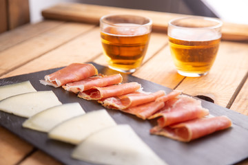 beer and cheese and serrano ham board from spain