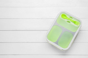 Plastic lunch box on white wooden background