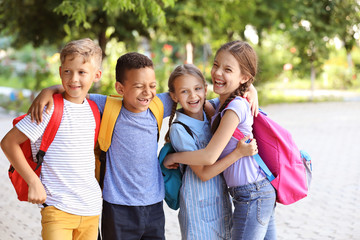 Group of cute little pupils outdoors
