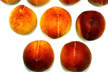 A few ripe peaches depicted on a white background, top view