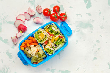 School lunch box with tasty food on light background