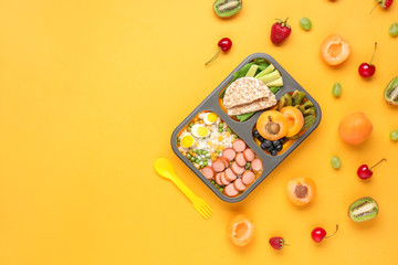 School lunch box with tasty food on color background