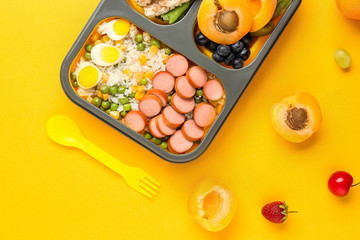 School lunch box with tasty food on color background