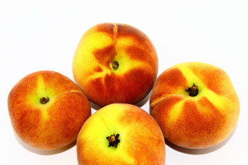 Fototapeta na wymiar Four peaches on a white background