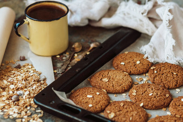 Oatmeal cookies and ingredients and coffee in rustic style