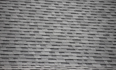 Roof shingles background and texture. dark asphalt tiles on the roof