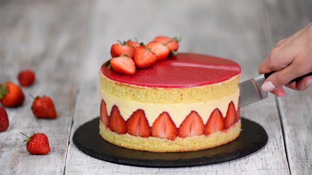 Strawberry cake. Fraisier cake on wooden background.