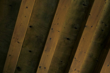 wooden roof made of many beams. main colors: yellow, green, black