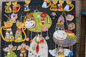 Neseebar, Bulgaria July 2017 : Ceramic figurines souvenirs hang for sale on the wall of the store