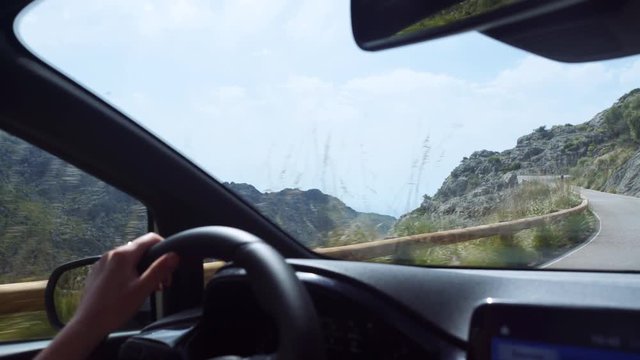 First person of front seat passenger point of view, looking at Mallorca Serra de Tramuntana scenery from inside a car