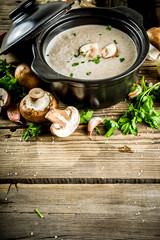 Homemade mushroom soup, old wooden background copy space