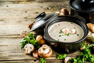 Homemade mushroom soup, old wooden background copy space