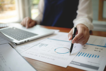 Accountant working with data documents calculating on business report.