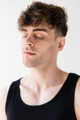 Obraz premium pensive man in black sleeveless shirt isolated on grey