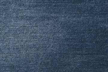 Shabby dark denim. Blue jeans background. Fabric pattern surface. Old, retro style of jean clothes. Vintage, fiber, textile texture.