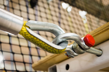 fastening a yellow nylon rope to a metal structure close-up. equipment in the obstacle course